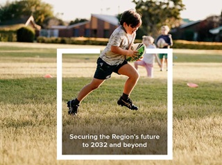 Boy holding football and running.