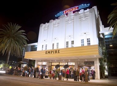 Empire Theatre external at night. Crowd of people waiting to enter a show.