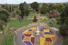 Birds eye view of Queens Park Botanic Gardens. Colourful blooms arranged in a geometric pattern.