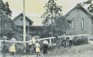 Historic photo of Drayton School with children standing out the front of the building.