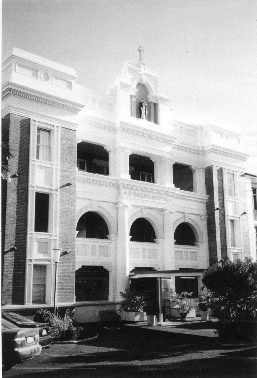 Black and white photo of St Vincent's Hospital original building. Three story brick building.