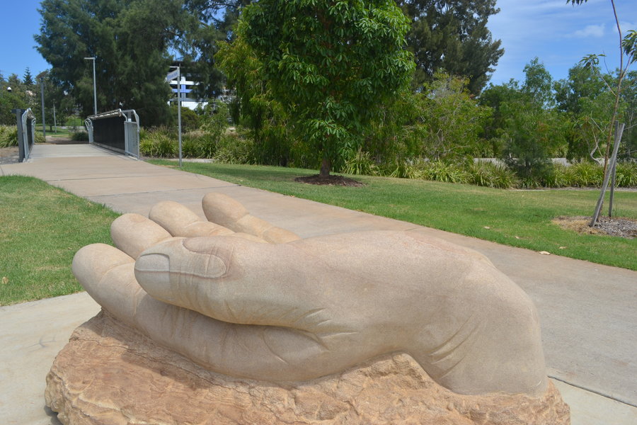 Photo of Clewley park with sandstone memorial to victims of abuse in foreground.