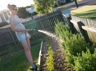 Woman watering garden