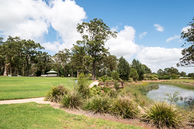 Peacehaven Park grass space, rotunda and lake.