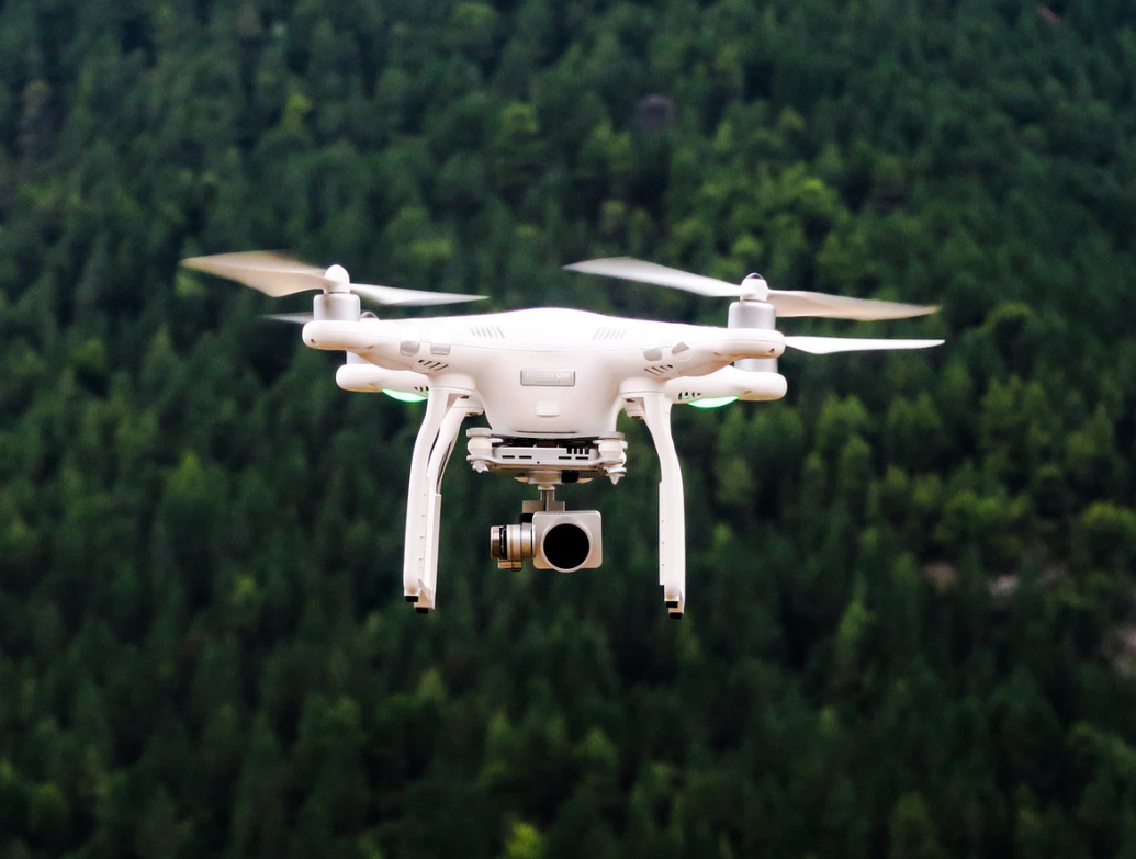 Image of a drone flying over a park