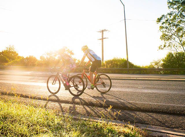 People riding bikes on the road