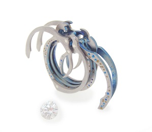 Titanium and silver ring crafted by 2017 Contemporary Wearables Biennial Jewellery Award winner Luke Abbot. Ring is very unique in design with two prongs extending from the top of the ring out each side. 